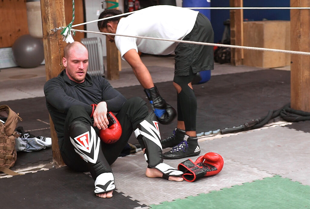 Dallas Jennings, left, rests after sparring with Darian Weeks on Friday, Feb. 19, at the Columbia Training Academy in Columbia.